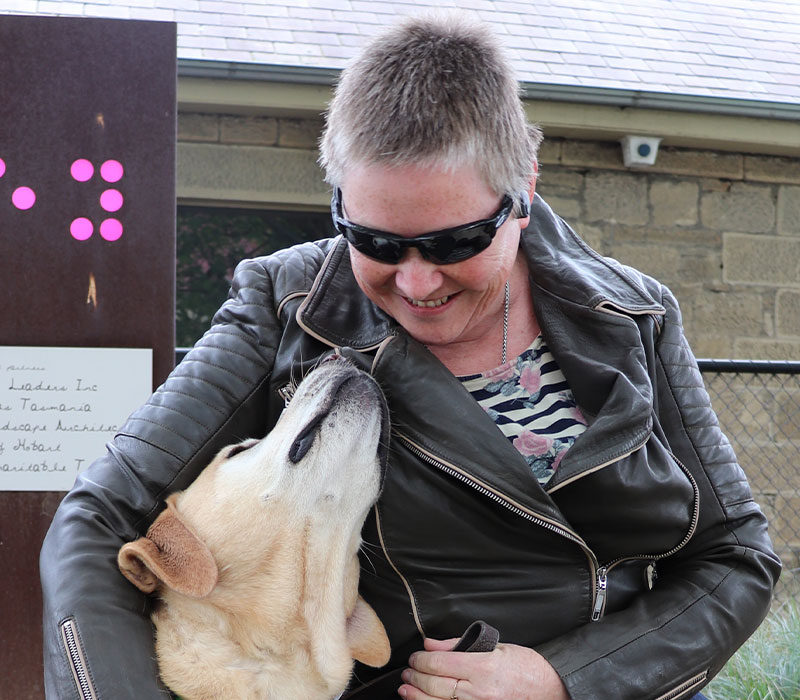 smiling lady looking at her Guide Dog