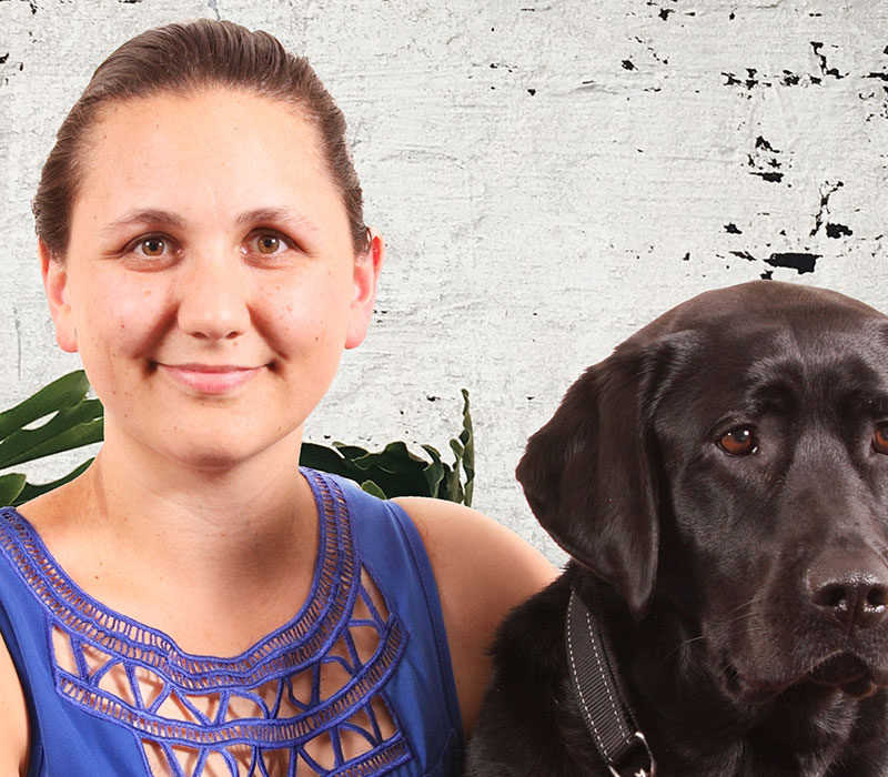 smiling woman with a guide dog