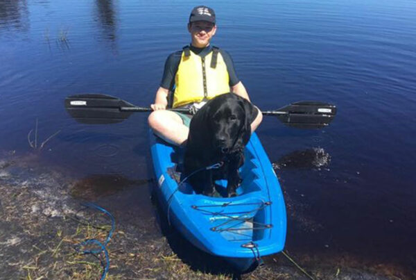 a pup and a young boy in a kayak