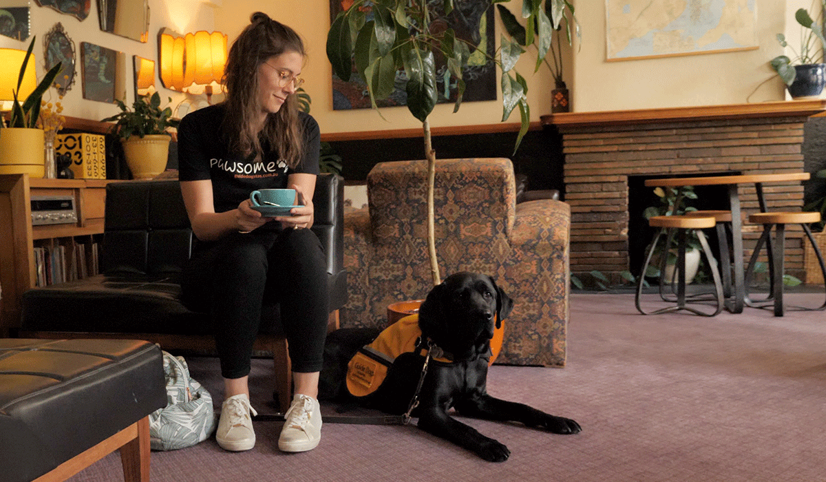 lady and guide dog in training in a hotel