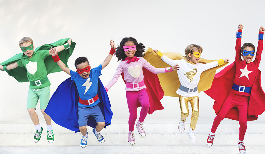 Five young children dressed in superhero costumes