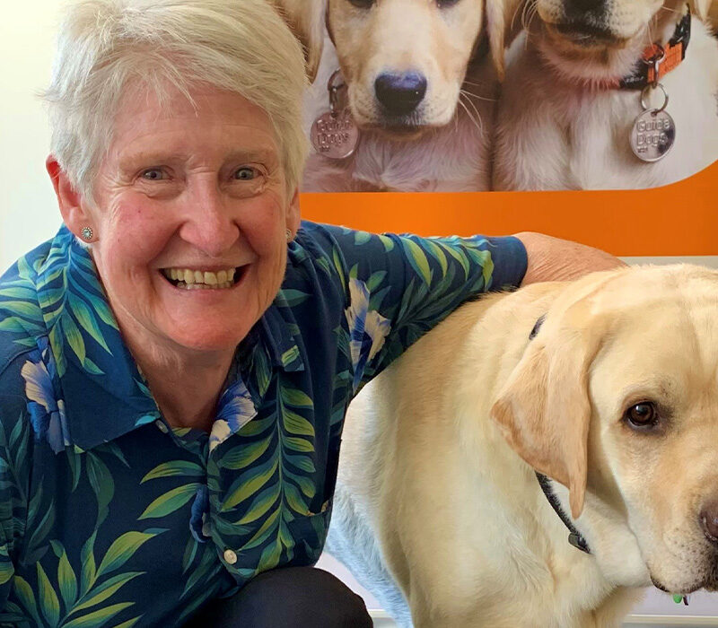 Sharon next to a golden Labrador