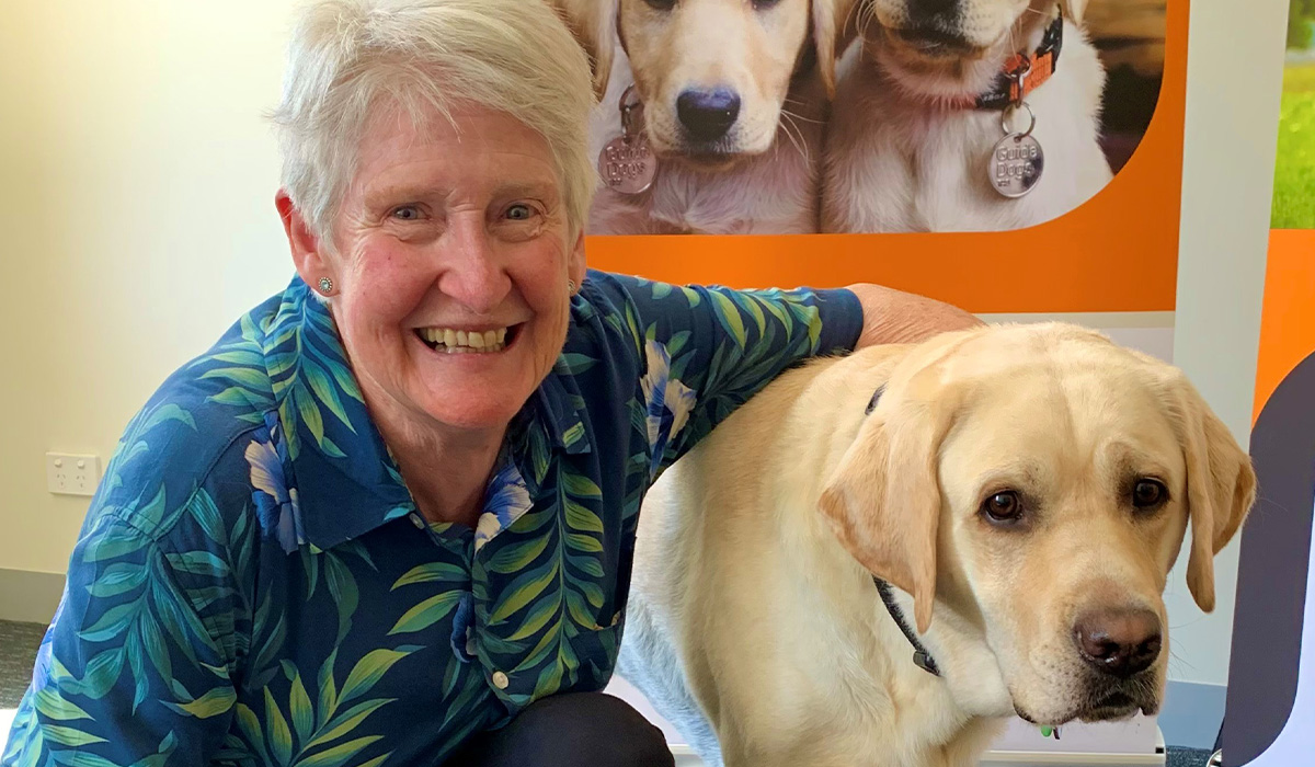 Sharon next to a golden Labrador